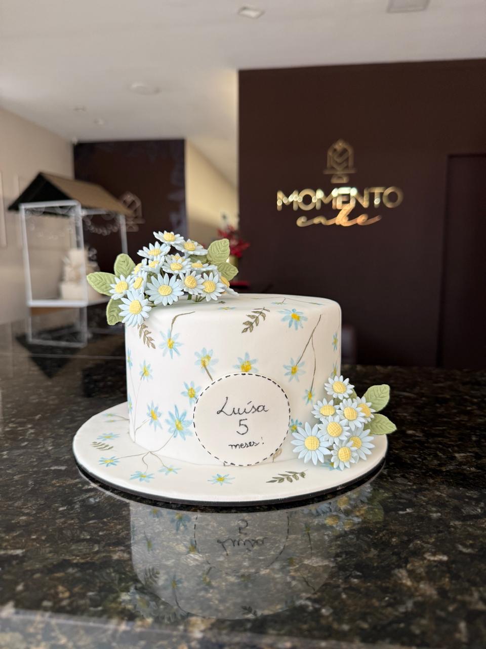 Bolo de mesversário decorado com margaridas em buttercream